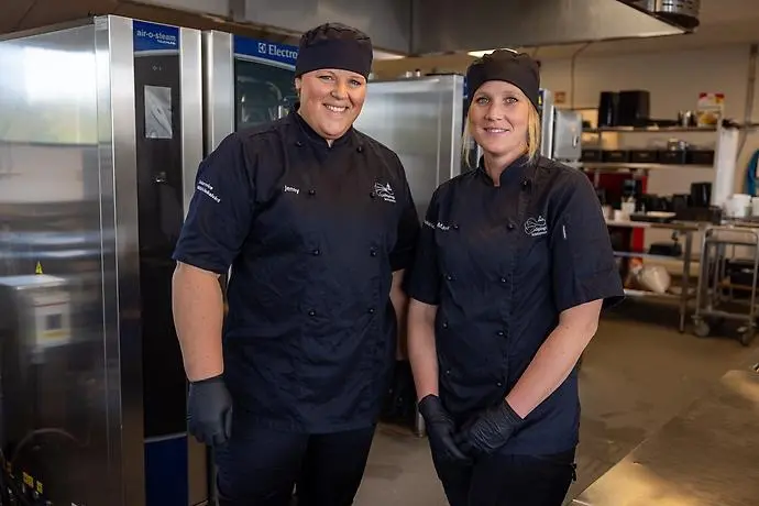 Två personer som tittar in i kameran. 